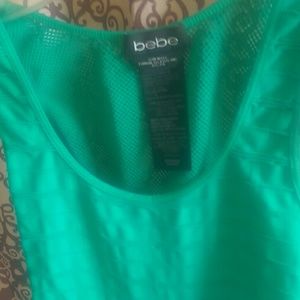 Green form fitting dress with fishnet sidings