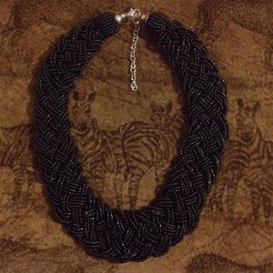 Thick beaded black necklace with clasp.