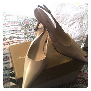 Cream color 2 1/2 inch heel sling back pumps.