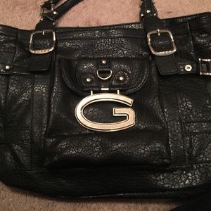 huge, black GUESS bag with 8 comparents