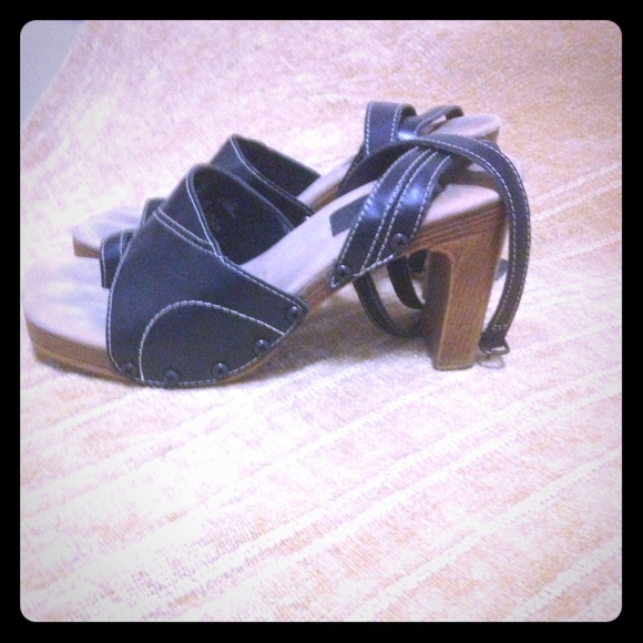 Wooden and black heels, with strap.