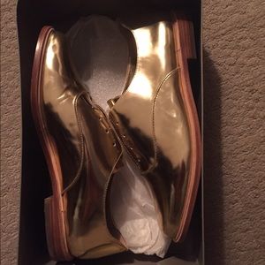 Brand new BCBG gold Oxford shoes; size 8.5