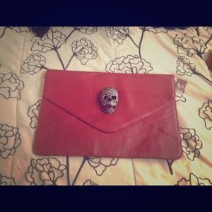 Red scull head clutch bag
