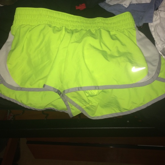 neon green Nike running shorts.
