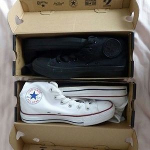 Black and white high top converse .