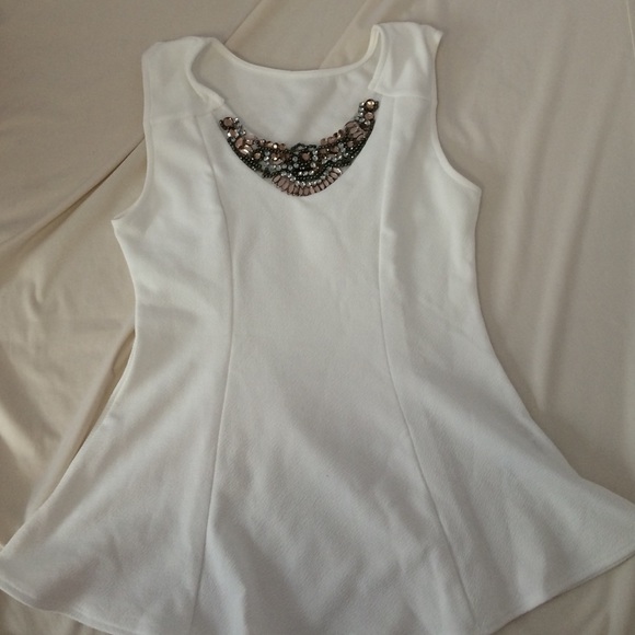 White peplum top with bedding on the top