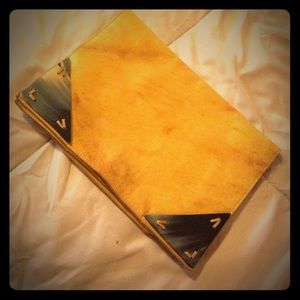 Mustard yellow leather clutch.