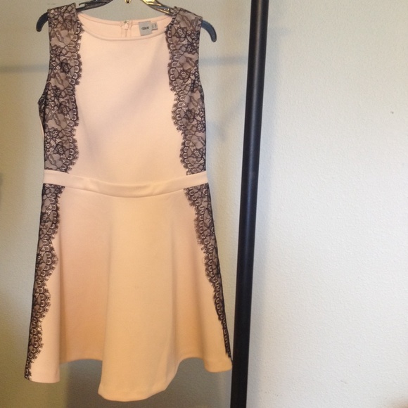 Nude skater dress with black lace trim