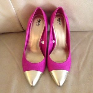 Bright pink high heels with gold tip toe