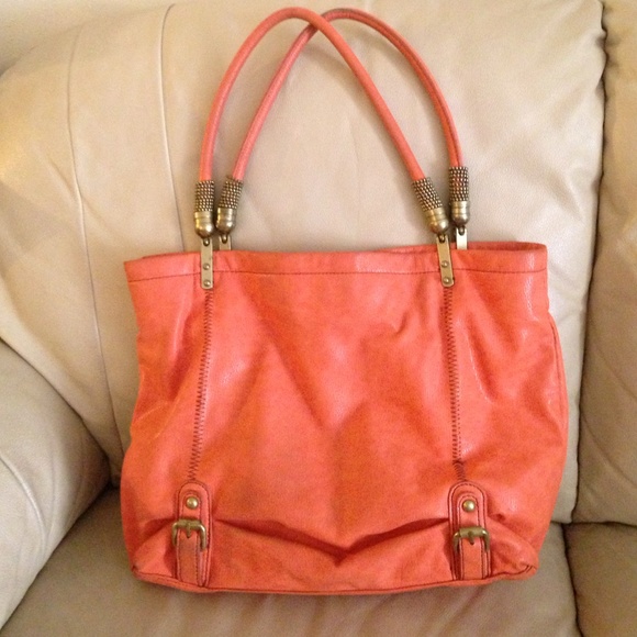 Orange purse with brass detail.