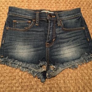 Frayed dark denim shorts for little girls.