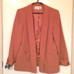 Burnt orange blazer with satin trim inside.