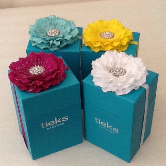 Tieks Accessories - Four Tieks boxes with flowers.