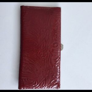 Red never been used patient leather Lodis wallet.