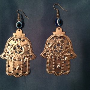 Hamsa earrings with evil eye detail.