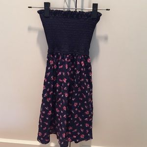 Strapless navy dress with cut out in the back .