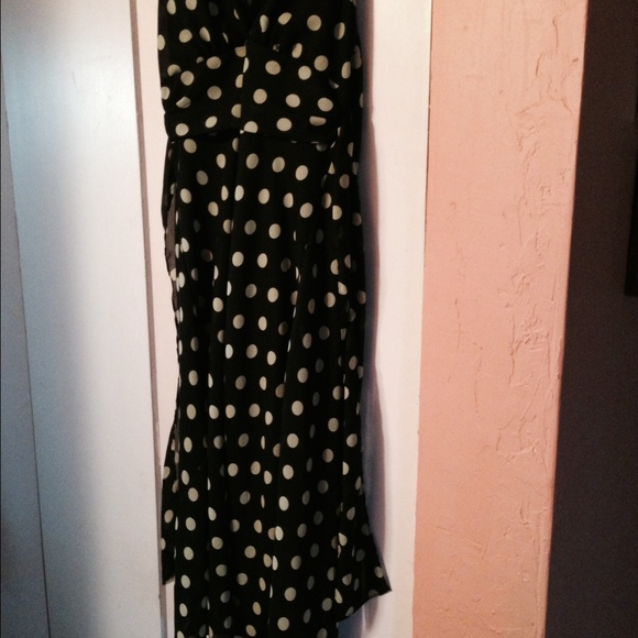 A dressy black/lime green polka dot sun dress .