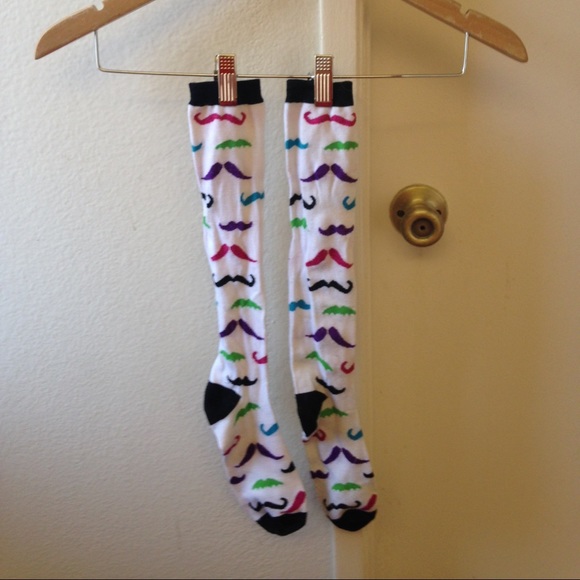 White knee high socks with colorful mustaches.