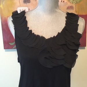 Black tank top with ruffled neck.