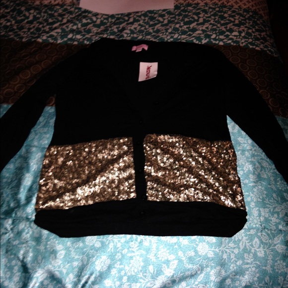 Black cardigan with gold sparkles.