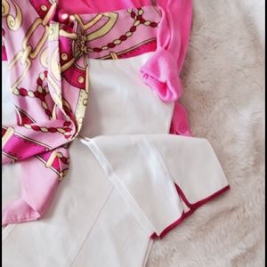 Ankle length white pants with attached sash/belt.