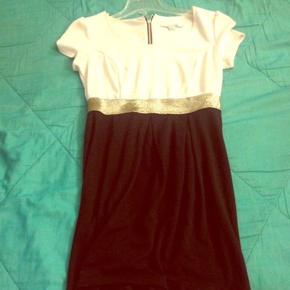 Ivory and black dress with gold waist trim.