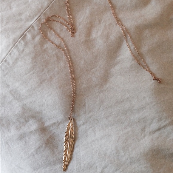 Long gold chain with feather charm