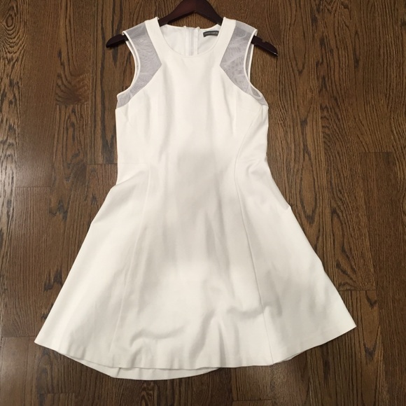 White sleeveless dress. Sheer paneling on shoulder