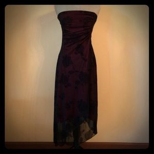 Asymmetrical black dress with red undertones