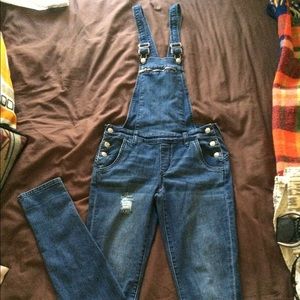 bebe skinny overall with light distress.