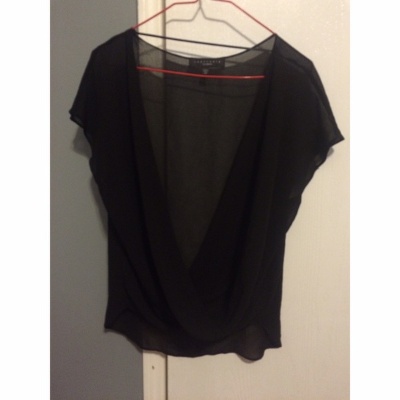Sheer , drop neck / twist black shirt .,