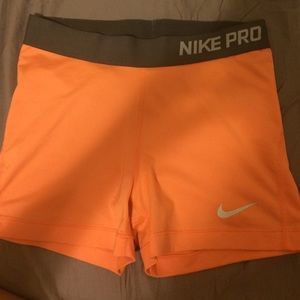 Orange and grey Nike Pros