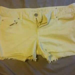 AMERICAN EAGLE YELLOW CUT OFF DENIM SHORTS