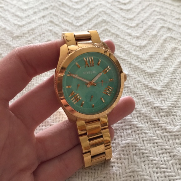 Rose gold Fossil and teal faced watch.