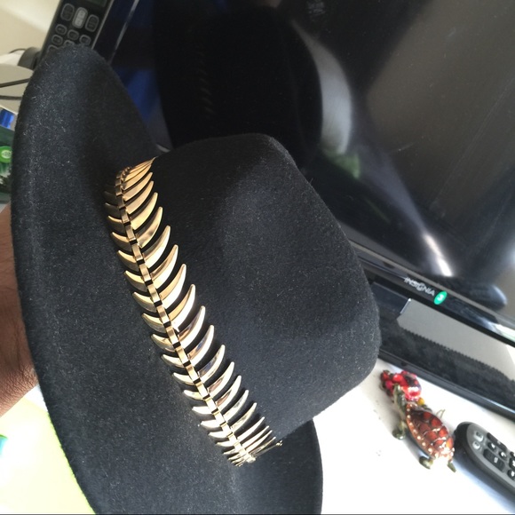 Black popular hat with some type of gold trimming