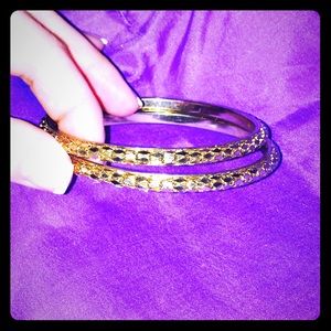 2 gold colored bangle bracelets