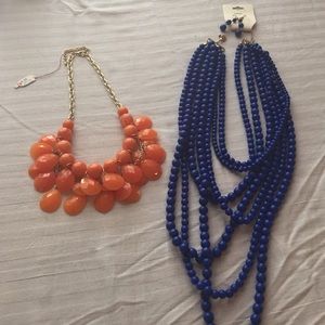 2 Statement necklaces, one with matching earrings.