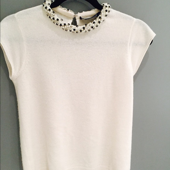 White cashmere top with beaded necklace