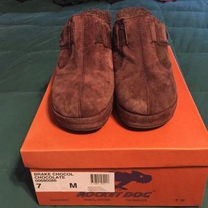 Brown suede Rocket Dog wedge heel clogs.