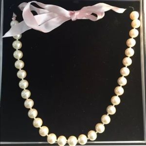 Adorable white pearl necklace with pink bow tie