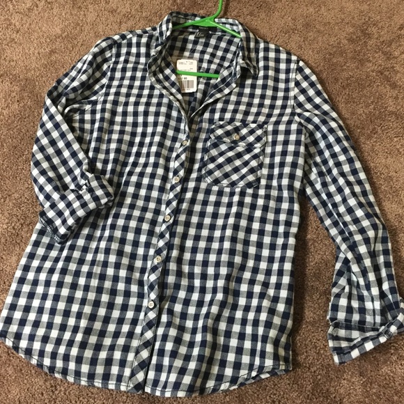 White/navy checked, button up shirt.