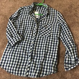 White/navy checked, button up shirt.
