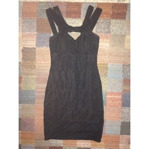 Body-hugging black cleavage-bearing cocktail dress