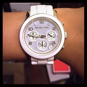 White and Silver Mk watch.