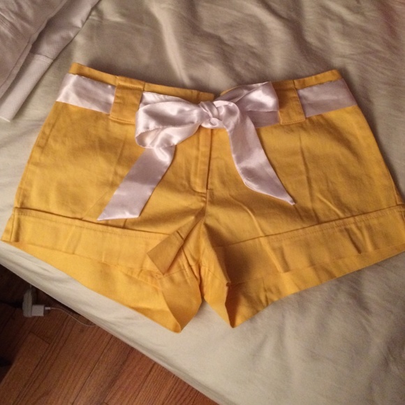 Yellow shorts with silk white bow as a belt.