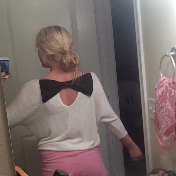 White sweater with black bow