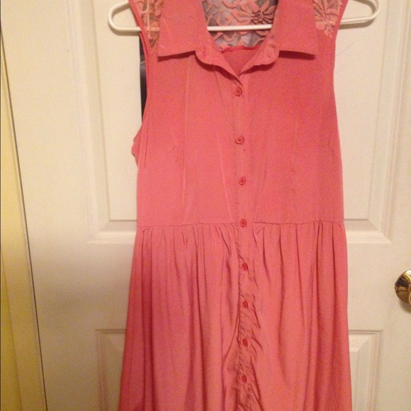 100% polyester peach t-shirt dress with lace back.