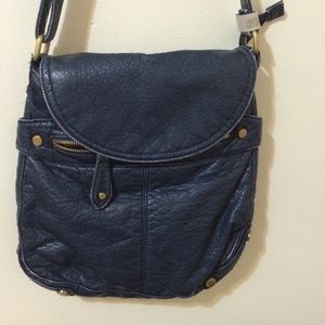 Soft blue bag with gold zippers