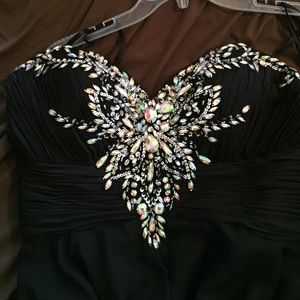 Black strapless prom gown with gems.