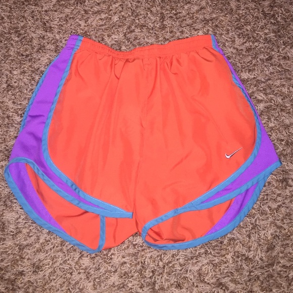 Bright orange, light blue, and purple Nike shorts